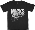 Washed black t-shirt with a live performance photo of Micks and the text 'Micks Australia 2026' in a stylised tour art layout.